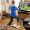 A woman is using a Wii to HDMI converter adapter on a floor mat to connect a console to a television.