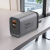 A silver wall charger with USB-A and PPS ports is placed on a light gray shelf.