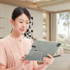 A woman holds a silver magnetic wireless charging module for an iPad Pro in a light pink dress.
