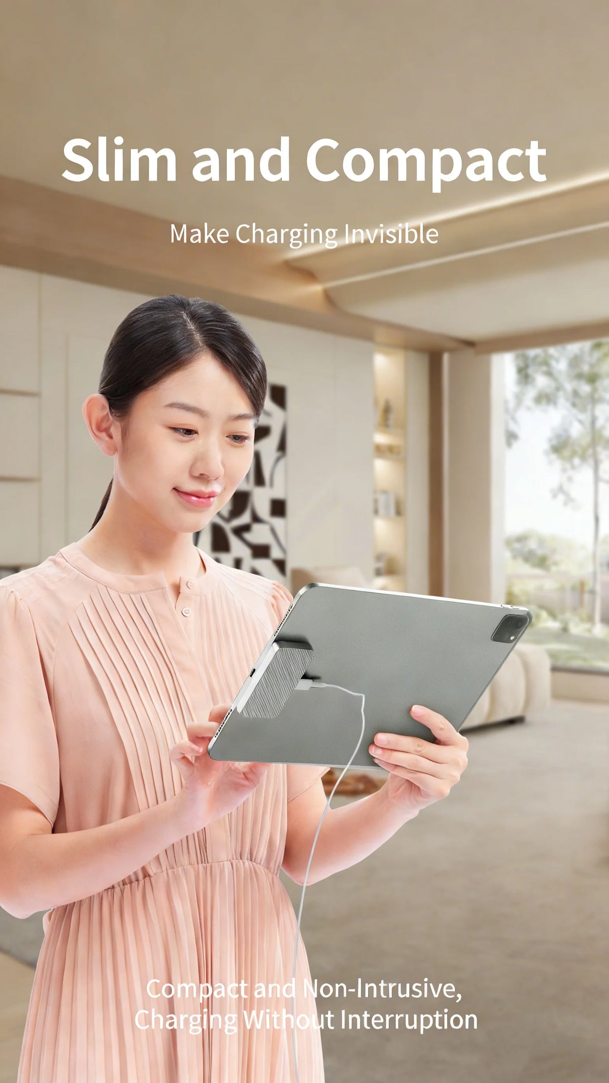 A woman holds a silver magnetic wireless charging module for an iPad Pro in a light pink dress.