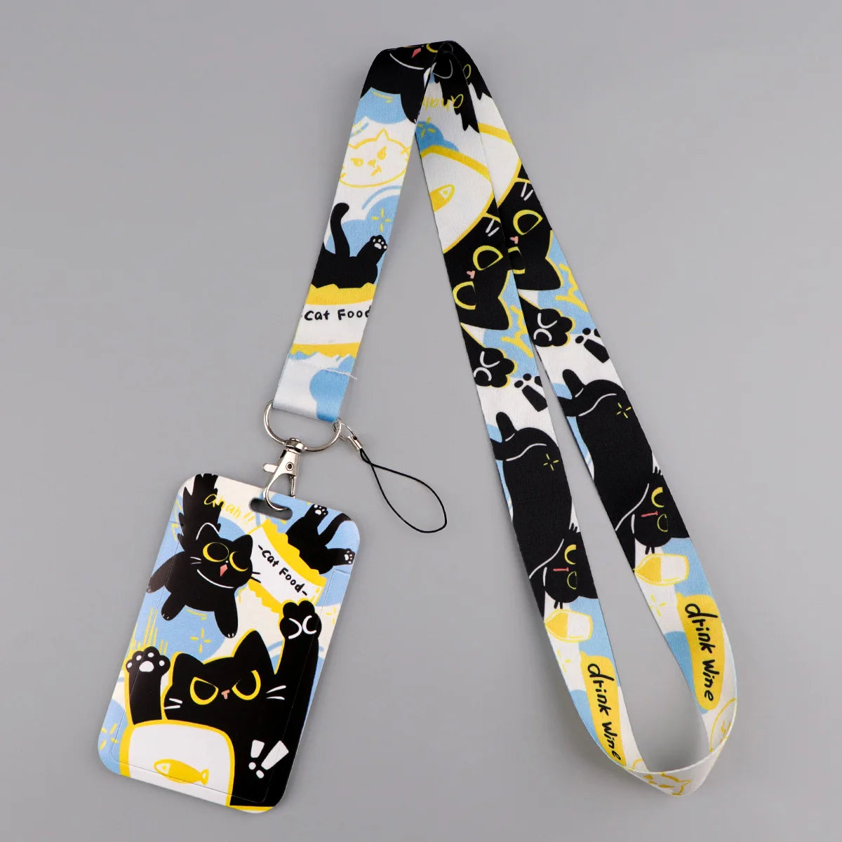 A black and white patterned cat themed lanyard with a card holder attached.