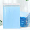 A stack of light blue bubble mailers with a white header, showing the self-sealing padded envelopes.
