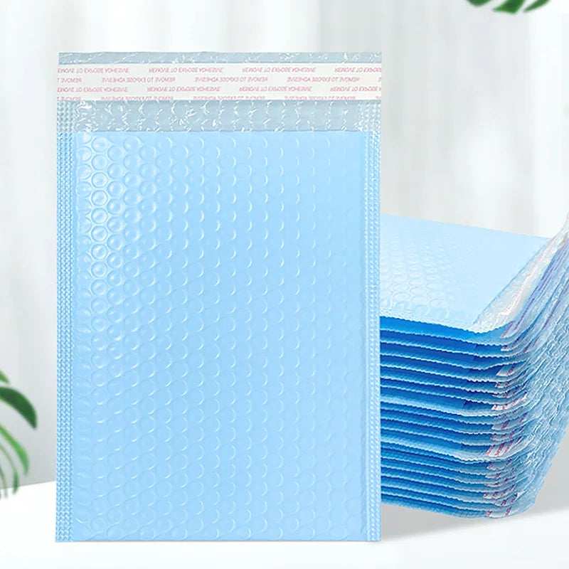 A stack of light blue bubble mailers with a white header, showing the self-sealing padded envelopes.