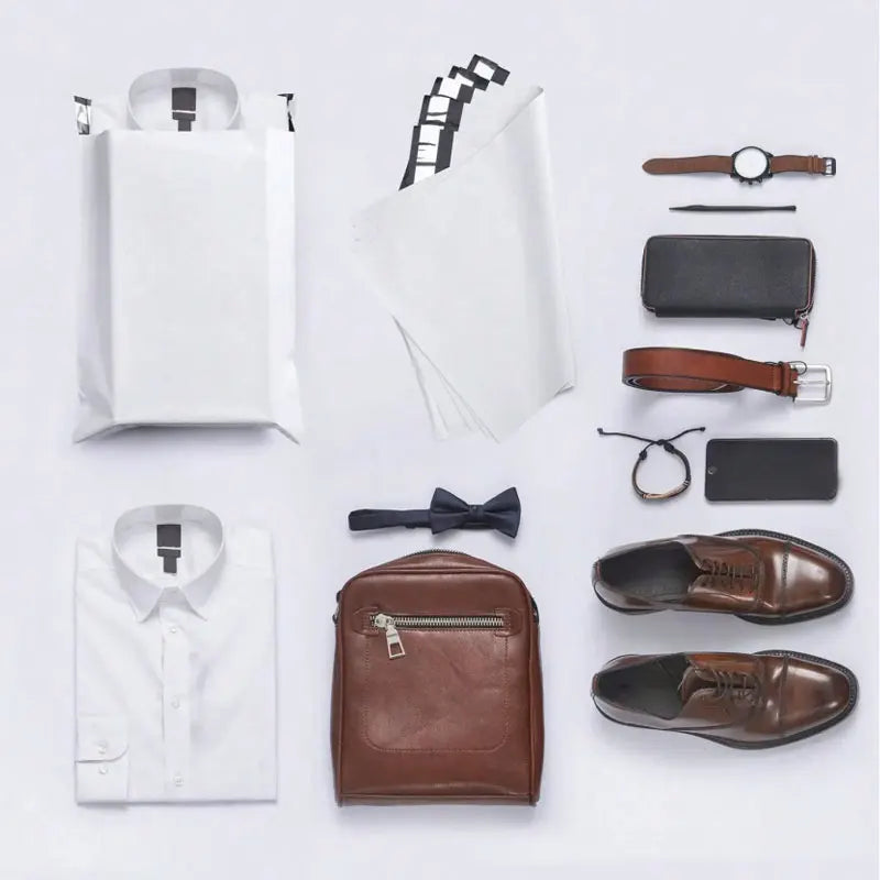 A collection of reusable self-sealing packaging bags, including white pouches, a leather wallet, and brown dress shoes.