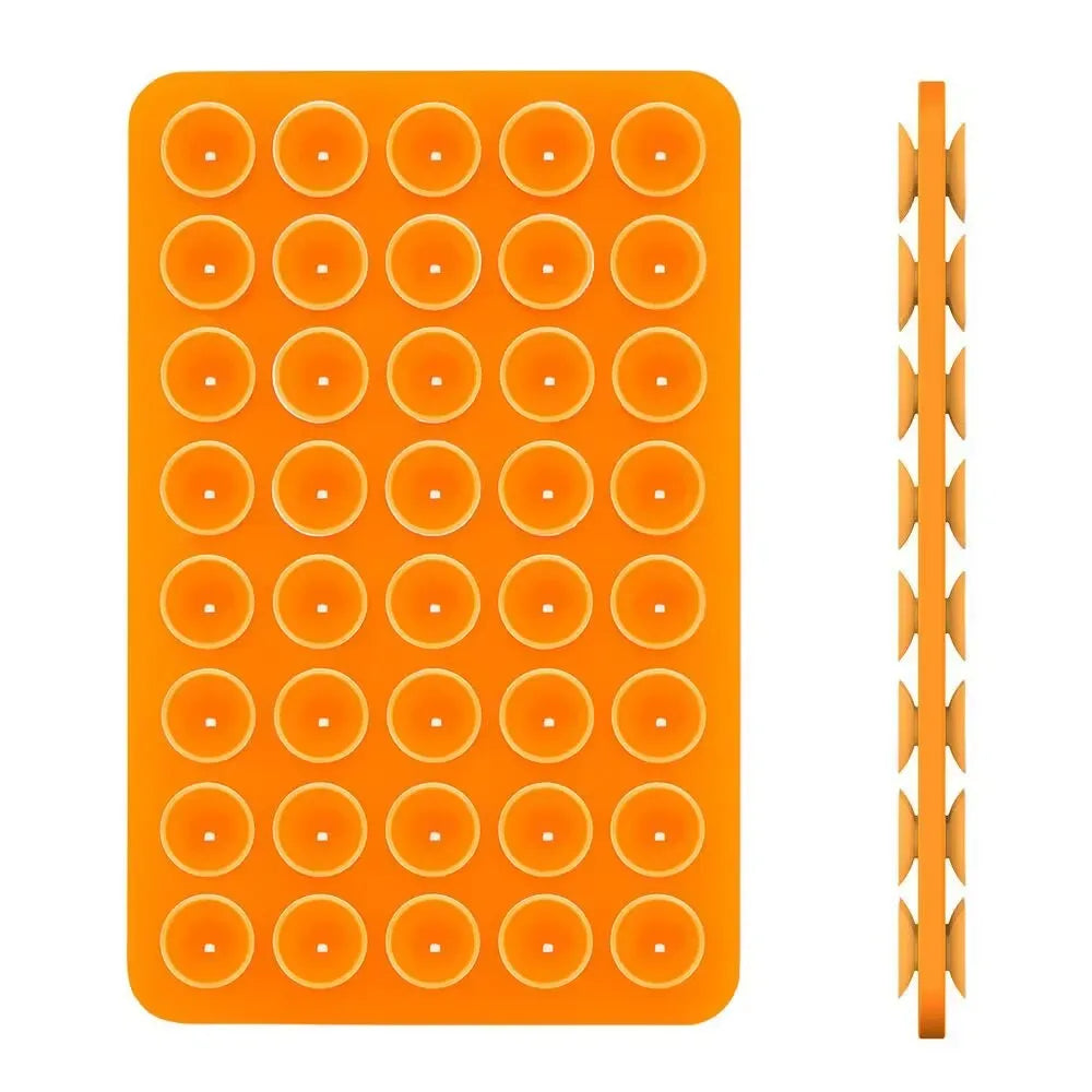 Orange double-sided silicone suction cup phone mount with multiple holes for secure grip