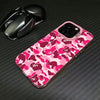 A pink leopard print anti-fall phone case for an iPhone is shown next to a black wireless mouse.