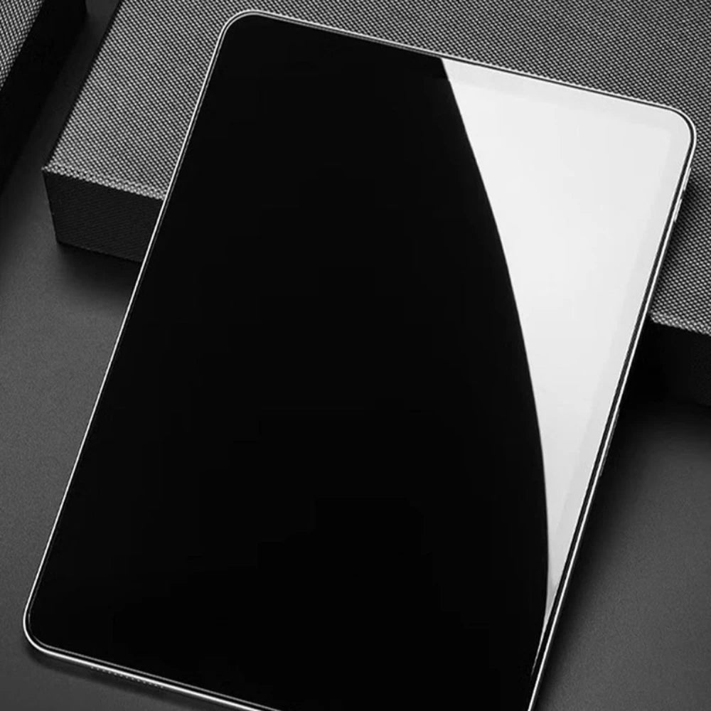 A black iPad screen with a clear glass protector is shown on a dark surface.