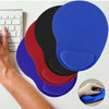 A hand is shown interacting with a colorful ergonomic mouse pad featuring blue, red, and black sections.