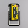 A black and yellow ID badge holder featuring a cassette tape design and a scale marked up to 10000.