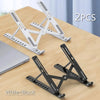 Two portable folding laptop stands in white and black are shown on a wooden surface.
