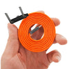 An orange charging cable with a folding stand is held in a hand.