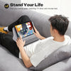 A person is using a multi-angle adjustable tablet and phone holder while relaxing on a couch watching TV.