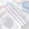 A set of four Kawaii Pearl Angel gel pens in various pastel colors and designs are displayed on a white towel.