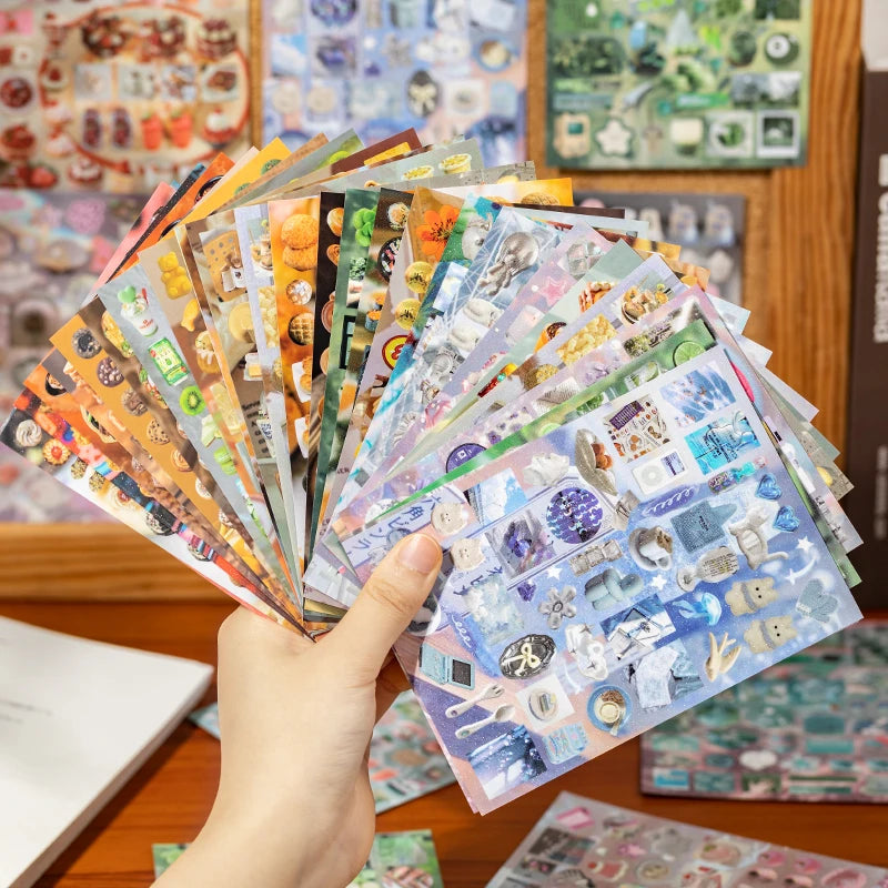 A hand holds a fan of Y2K aesthetic cut film stickers featuring various colorful and iridescent designs.