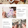 A set of vintage floral square scrapbook paper sheets displayed with tools and examples of layering techniques.
