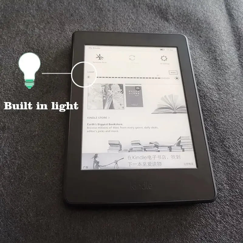 A black Kindle e-reader device is shown on a dark gray surface, with a light bulb icon indicating built-in light.