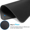 Black contoured rubber mouse pad shown from the side, demonstrating grip on a flat surface.
