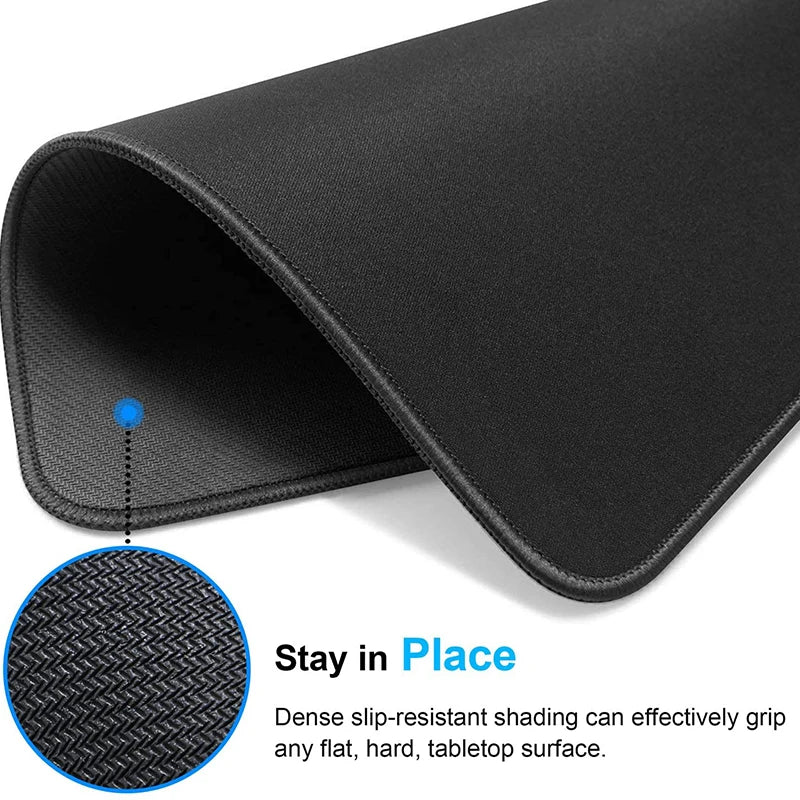 Black contoured rubber mouse pad shown from the side, demonstrating grip on a flat surface.
