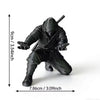 Matte black ninja figurine used as a pen holder, shown in a standing pose.