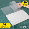 A sheet of clear thermal laminating pouch is shown next to an A4 sized white sheet on a grid background.