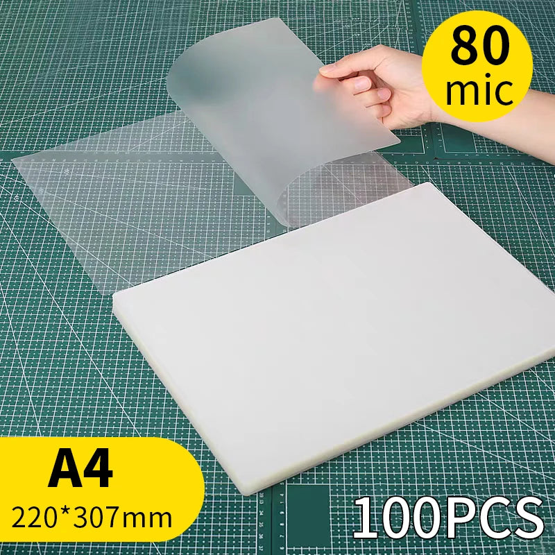 A sheet of clear thermal laminating pouch is shown next to an A4 sized white sheet on a grid background.