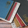 A collection of retro gold foil inserts in various colors and textures for notebooks and journals.