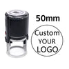 A black self-inking stamp with a clear base and a lid, featuring text indicating a 50mm size for custom logo printing.