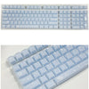 A close-up view of translucent ice crystal mechanical keycaps for Cherry MX switches arranged in a plastic tray.