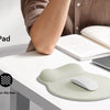 A hand is using an ergonomic mouse pad with wrist rest on a laptop, demonstrating wrist support.