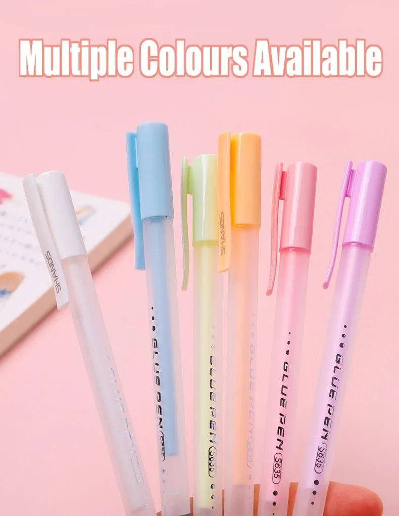A collection of multiple colored glue pens, including blue, green, and yellow shades, displayed on a light pink background.