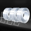 Three rolls of heavy duty clear double-sided gap tape are displayed on a dark surface.