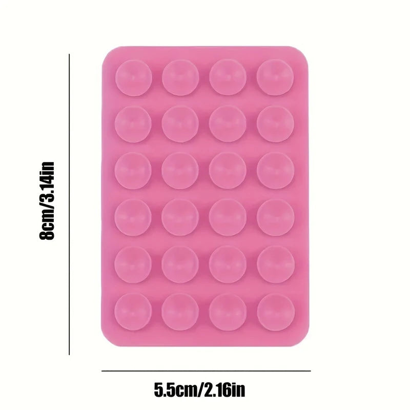 A pink multi-pack of silicone suction phone mounts with small circular holes.