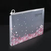 A transparent zipper file bag featuring a cherry blossom floral design on a gray background.