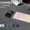 A close-up of a white mechanical keyboard and various devices demonstrating triple mode connection options.