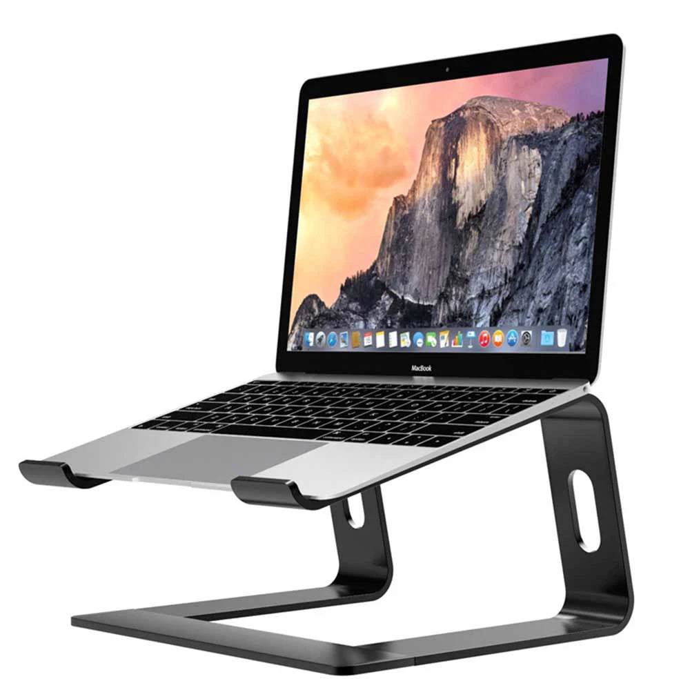A silver aluminum alloy laptop stand with an ergonomic tilt, holding a MacBook displaying a scenic landscape.