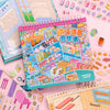 A colorful sticker book featuring a cute snack shop scene with various food items and DIY elements.