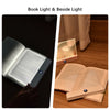 A rechargeable acrylic book light illuminating a page of an open book on a wooden surface.