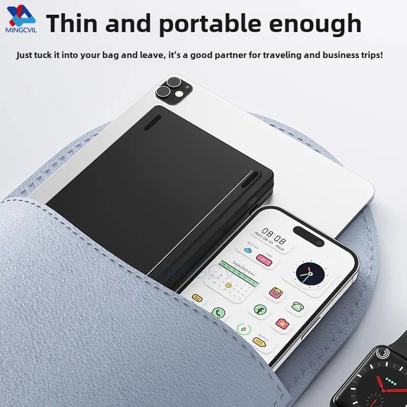 A black foldable Bluetooth keyboard is shown resting on a light blue fabric surface.
