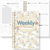 A weekly planner notebook with monthly layouts, habit trackers, and weekly goals sections.