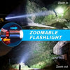 A zoomable tactical LED flashlight is shown illuminating a dark outdoor scene with foliage and a building.