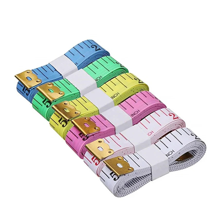 A stack of soft flexible measuring tapes in various colors including blue, green, yellow, and pink.