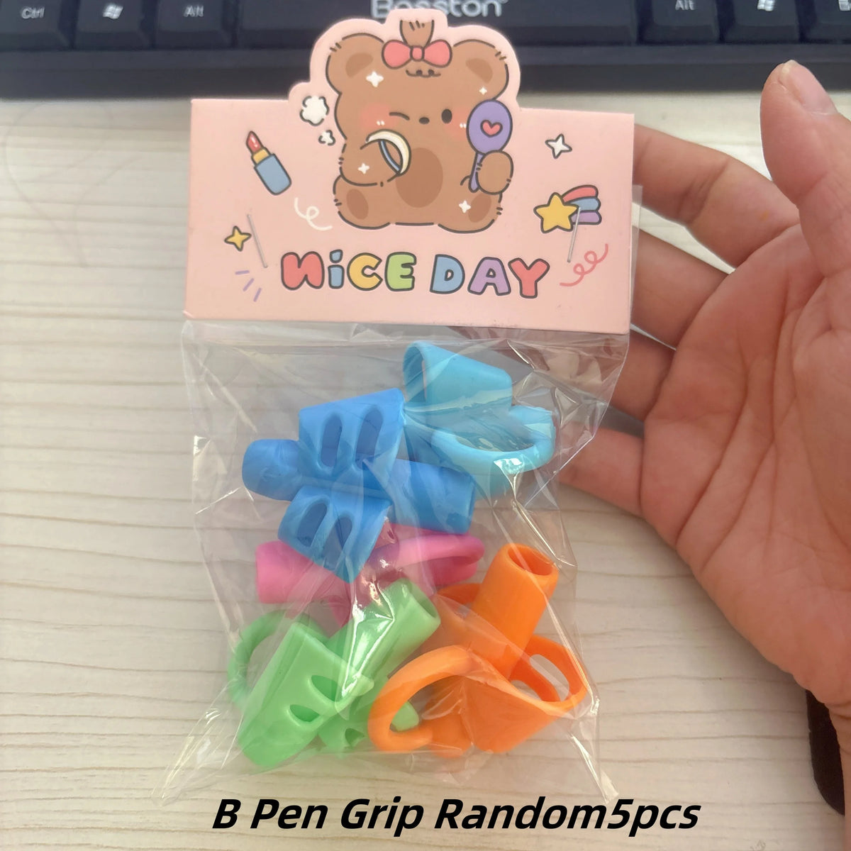 A clear plastic bag contains five colorful silicone pencil grips for kids.