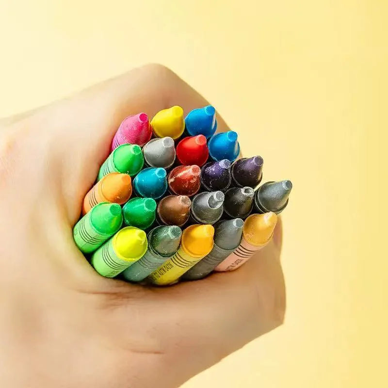A hand holds a collection of colorful washable non-stain crayons, showing various shades of pink, green, yellow, and brown.