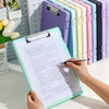A hand holds an open A4 document and photo storage file box next to a row of colorful file boxes.