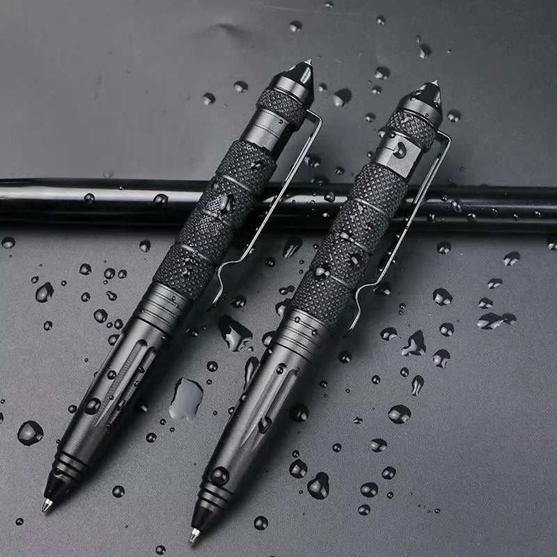 A pair of tactical aluminum pens are lying on a dark surface amidst water droplets.