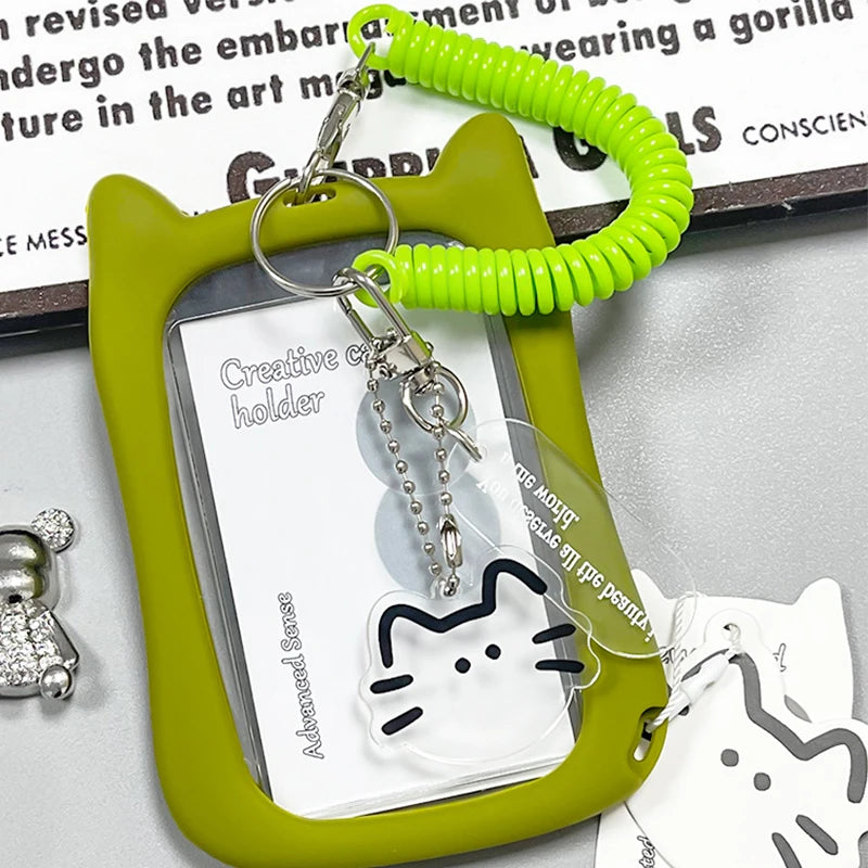A lime green card holder with a clear plastic insert and a bright green coiled keychain attached.
