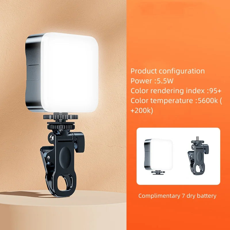 A black clip-on LED fill light with a white light panel is shown against an orange background.