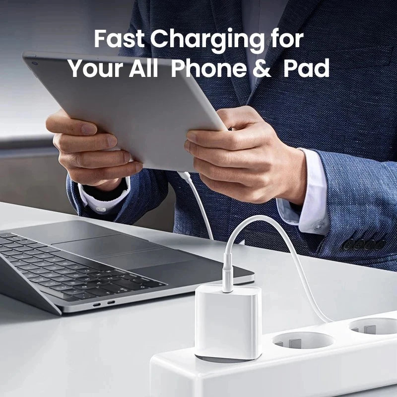 Hands are using a 40W PD fast charger to charge a tablet and a laptop.