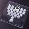 Klare Kunststoffschale mit weißen Butterfly-Keycaps und einem Keycap-Puller-Werkzeug für mechanische Tastaturen
