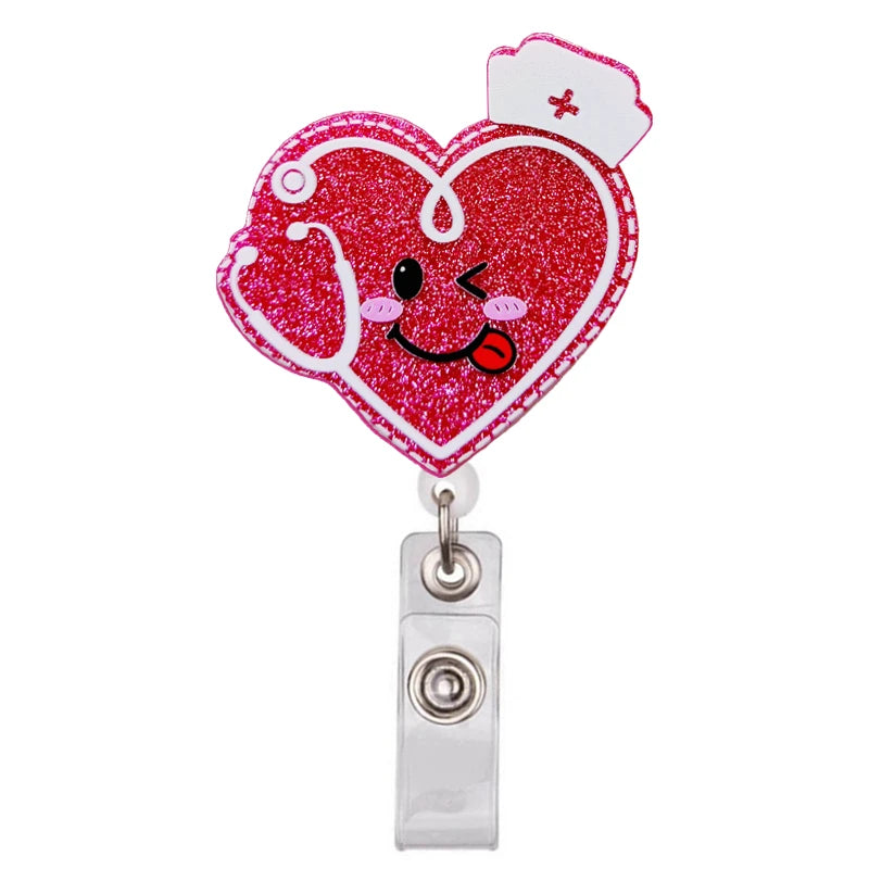 A heart-shaped, glittery red badge reel holder with a cartoon face and a small cross.